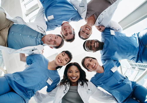 Medical personnel looking down at the camera